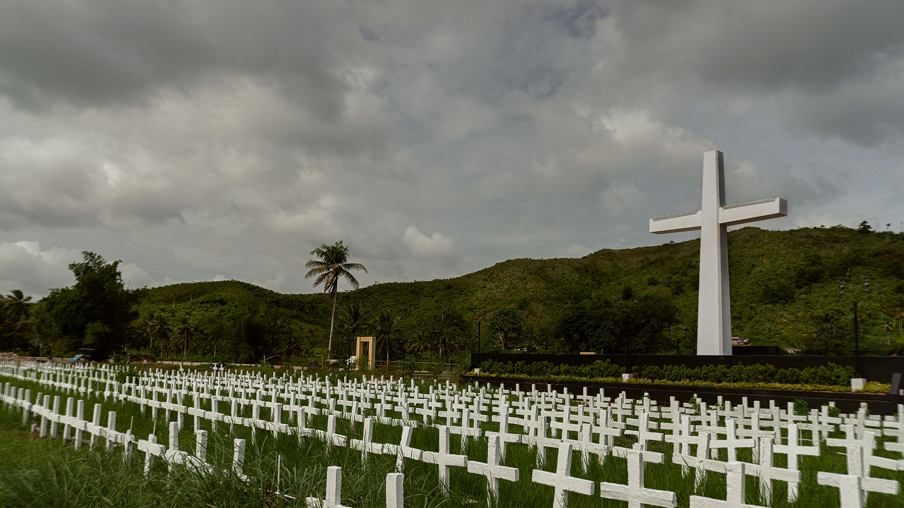 Good Boy Wolf Photographer, filmic landscape, Philippines, large white cross in a cemetery 