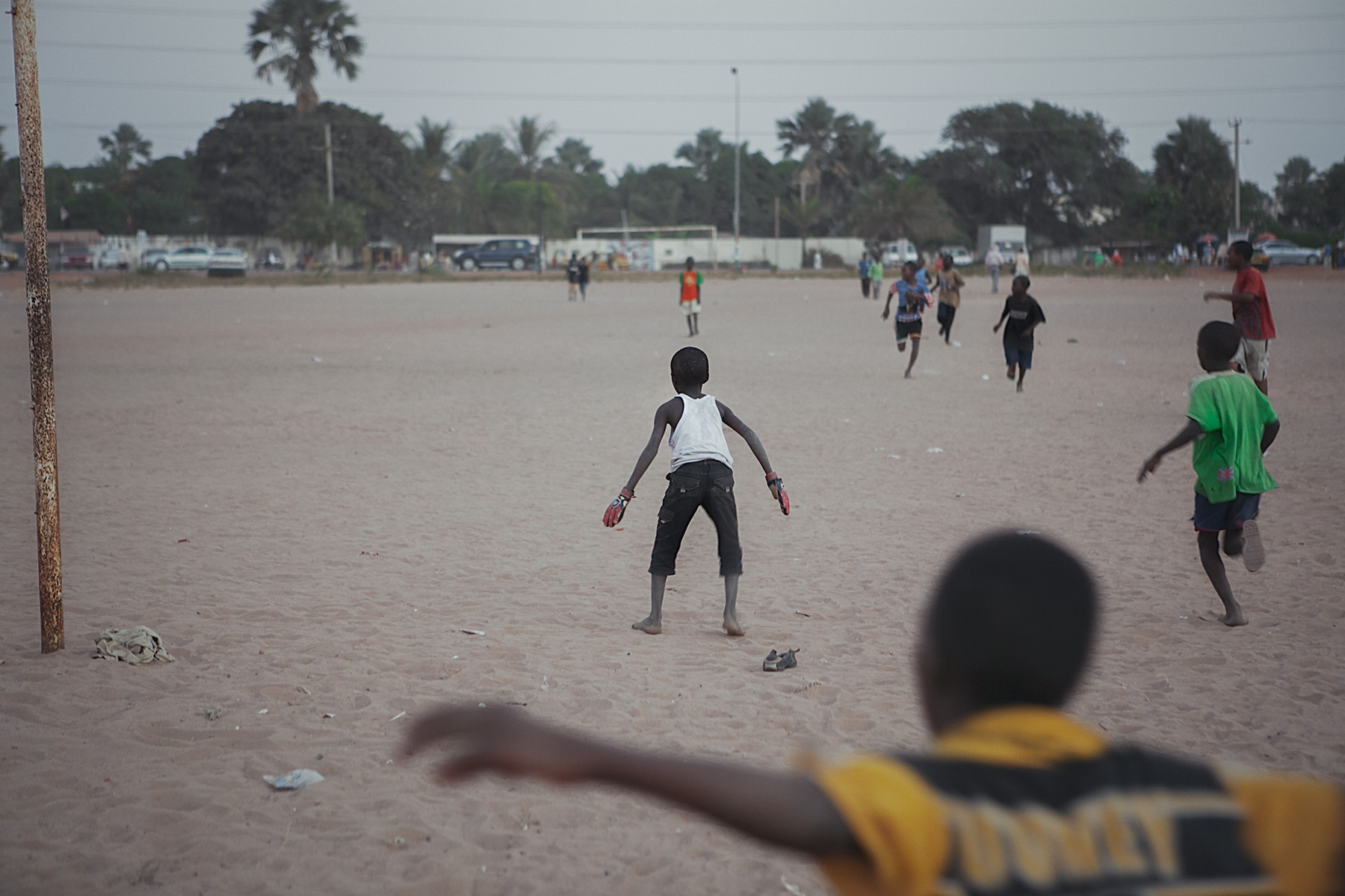 Good Boy Wolf Photographer, Gambia, west Africa, young boys running with a football 