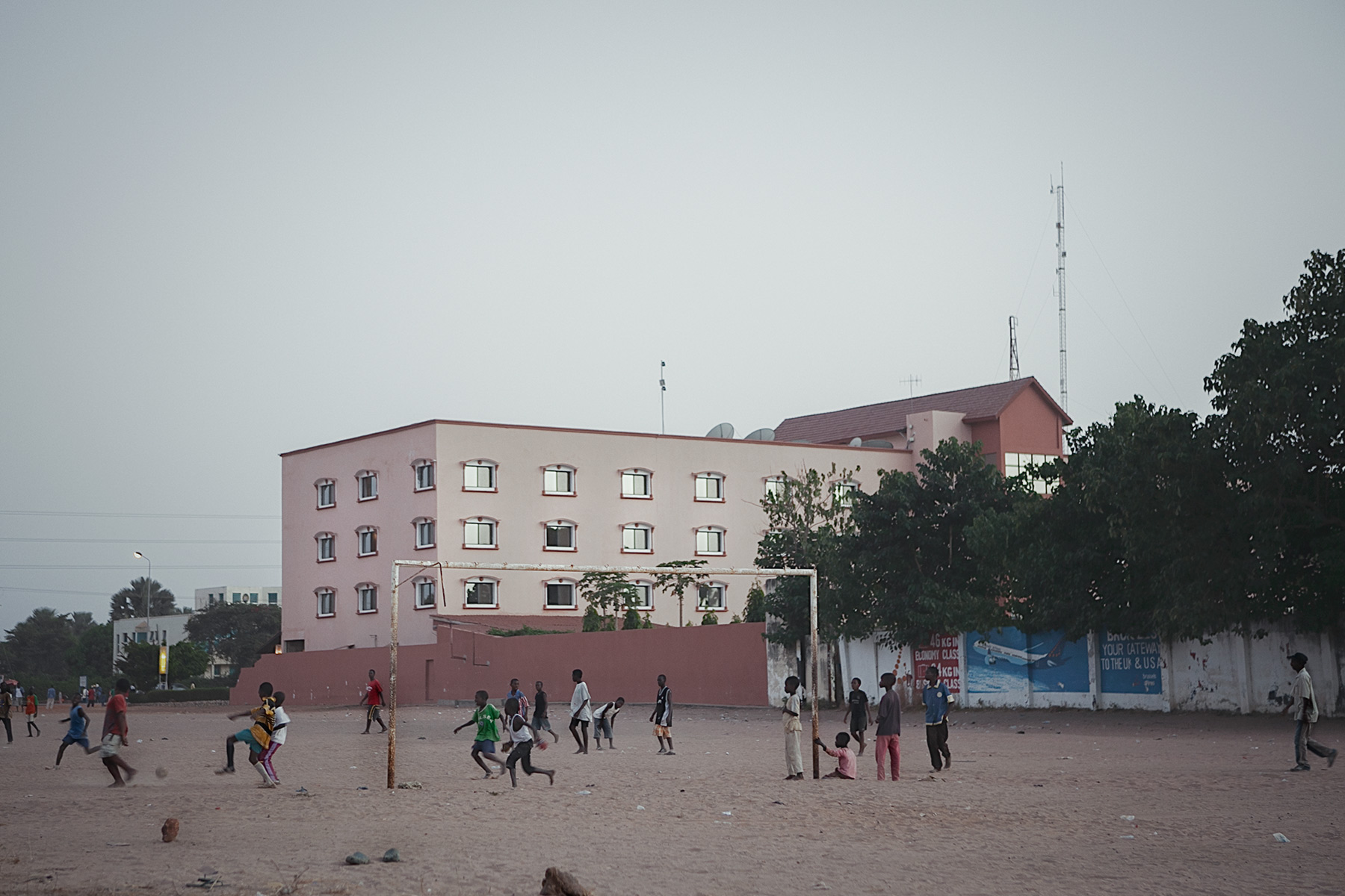 Good Boy Wolf Photographer, Gambia, west Africa, young footballers playing on dusty floor 