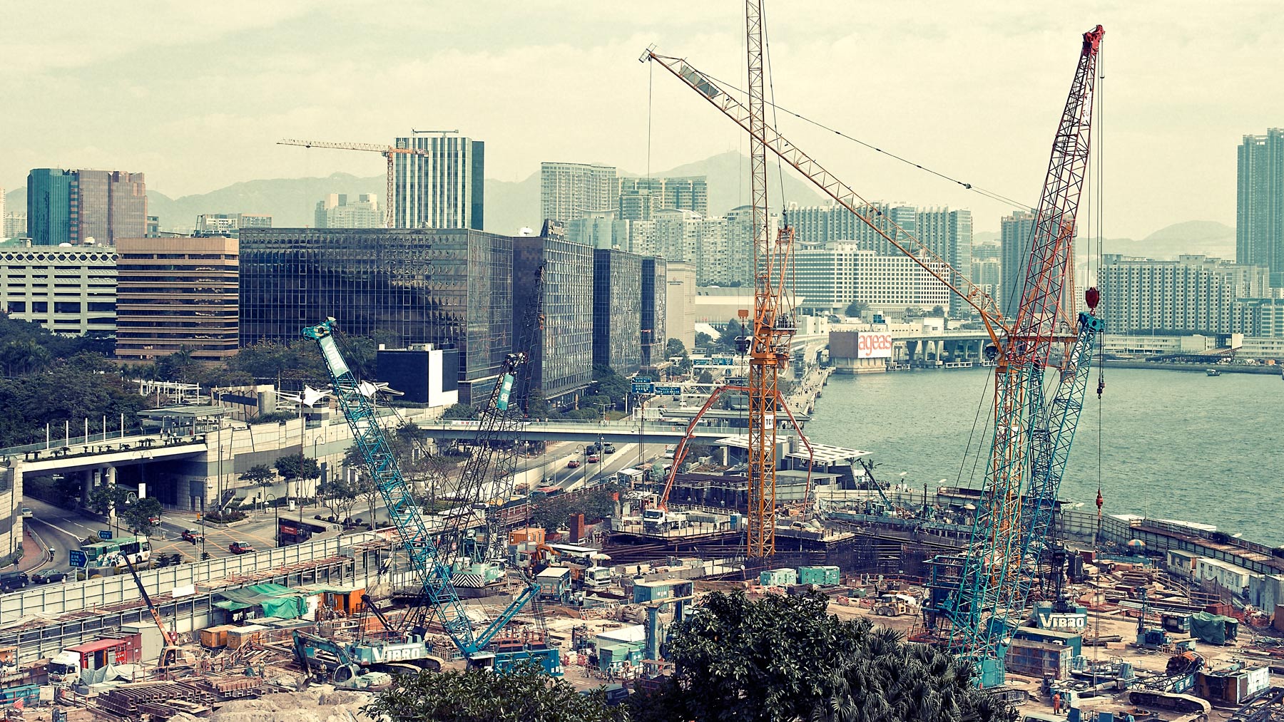 Good Boy Wolf Photographer, filmic landscape, building site in Hong Kong with cranes and building  site 