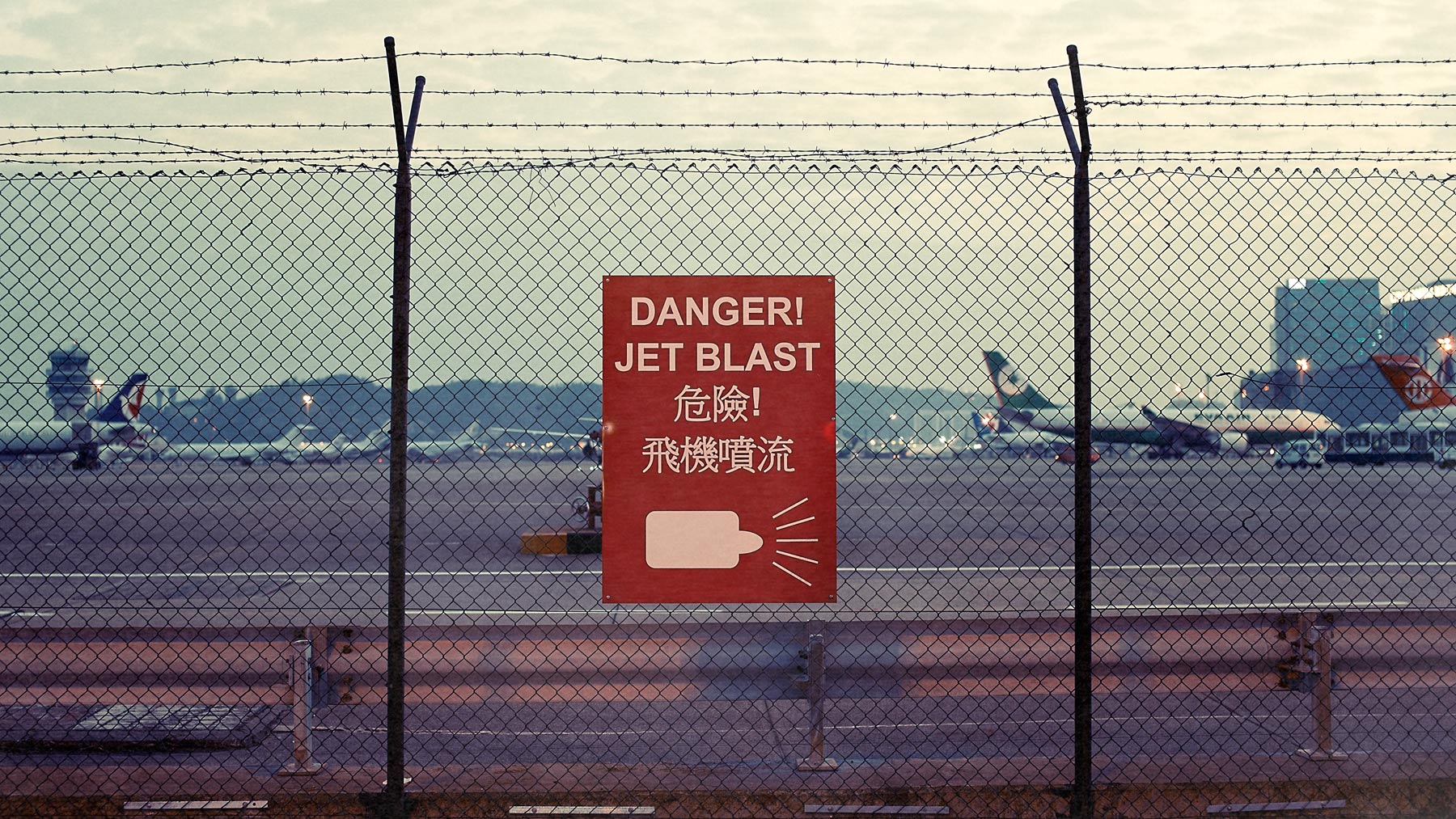 Good Boy Wolf Photographer, filmic landscape,  warning sign at Macau airport 
