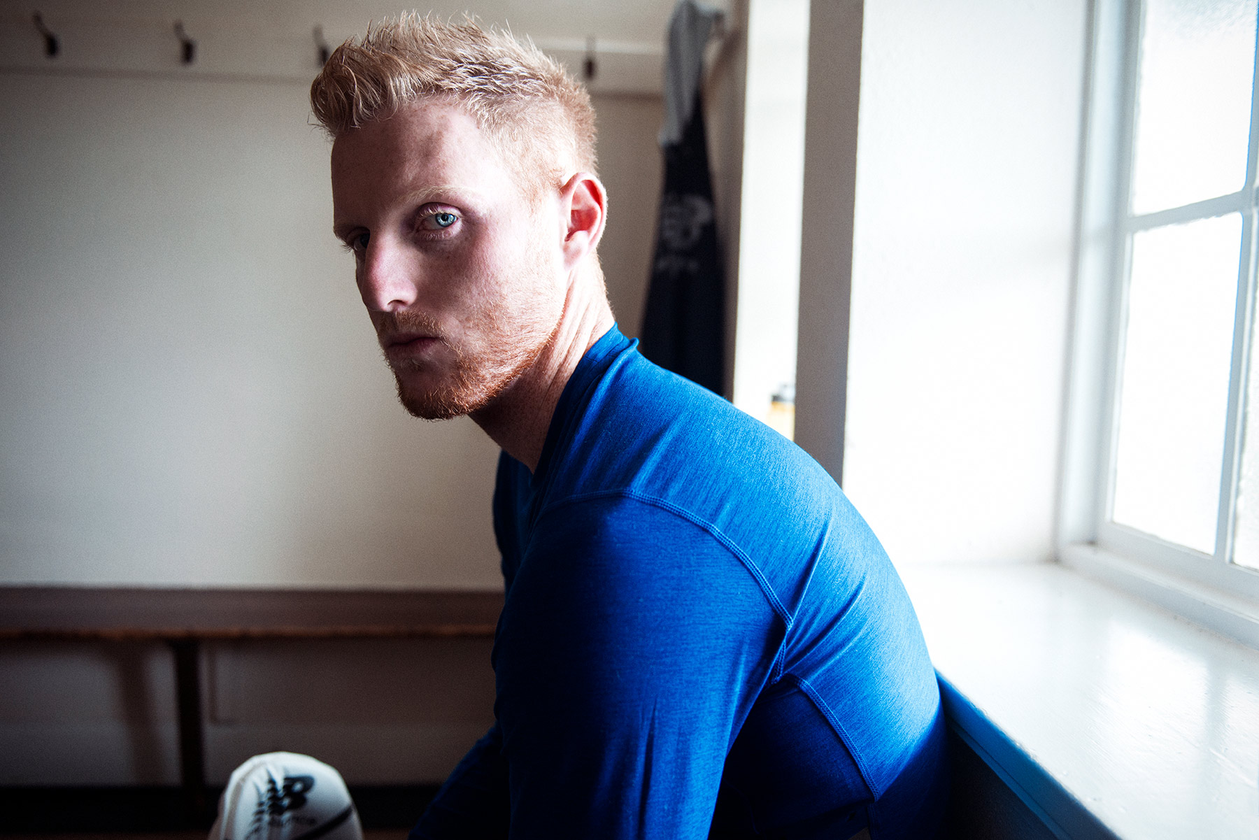 Good Boy Wolf Photographer, filmic portrait, ben stokes England cricketer sitting in a changing room 