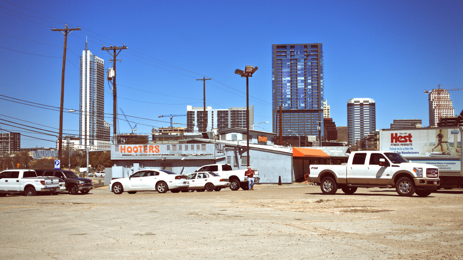 Good Boy Wolf Photographer, filmic landscape, Austin Texas, carpark filled with trucks 