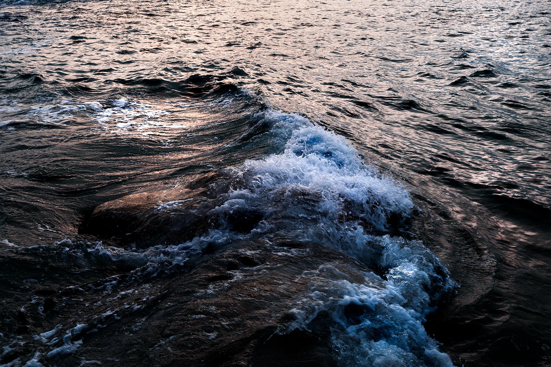 Good Boy Wolf Photographer, filmic landscape,  waves crashing in the sea. dark water 